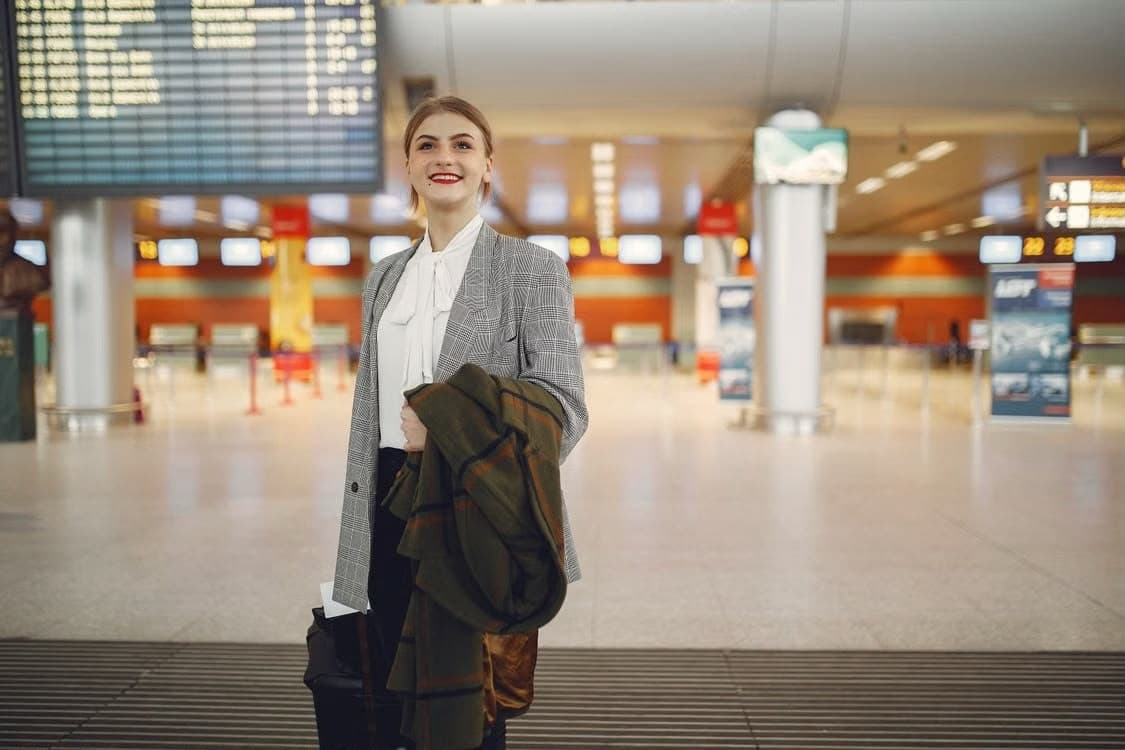 Smiling business traveller in an airport departures hall